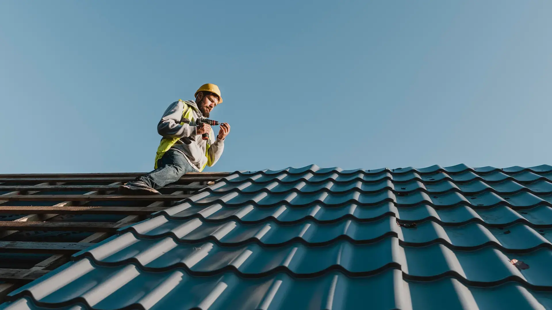 Long shot man working roof